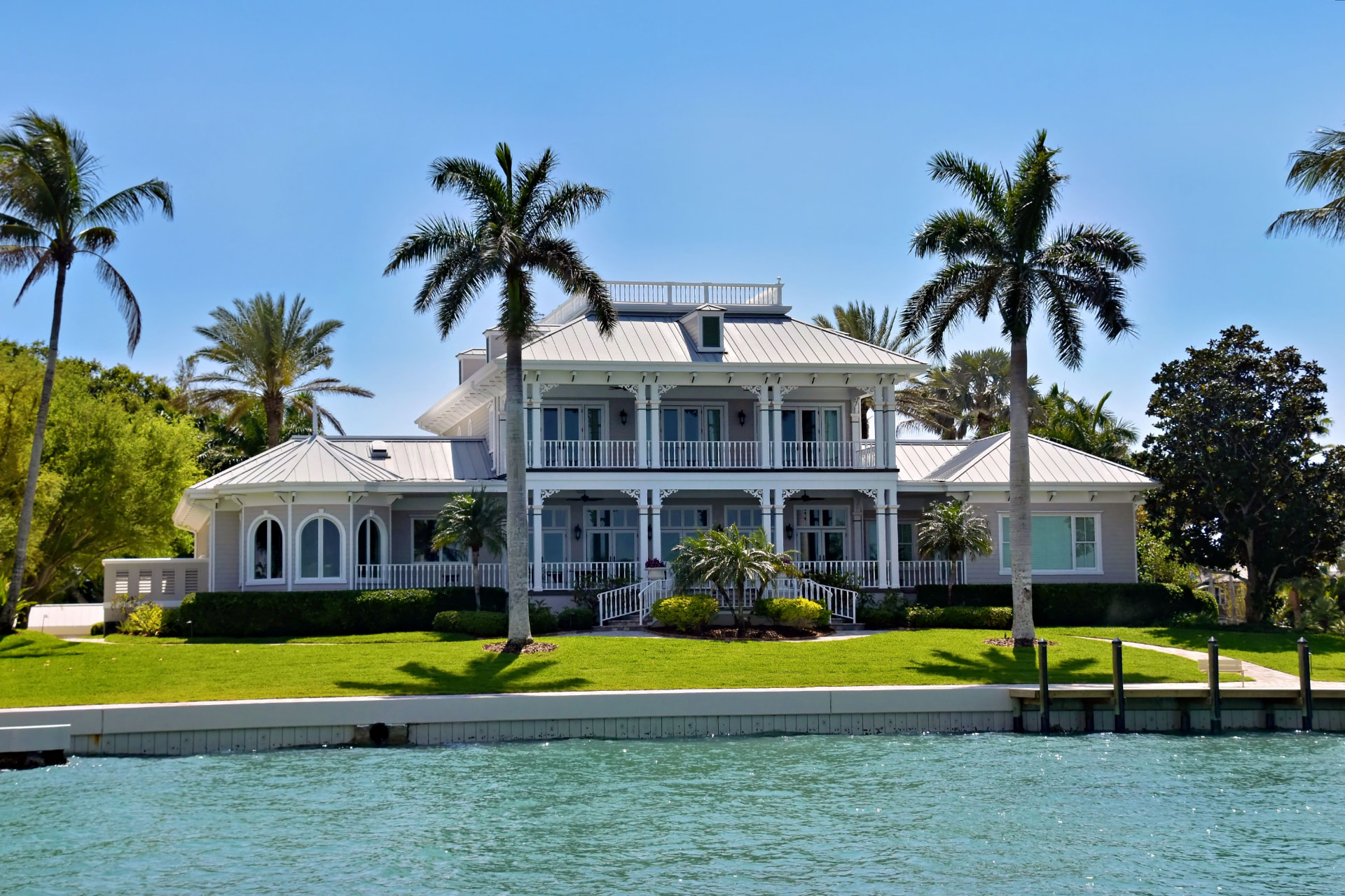 Waterfront coastal estate framed by palm trees